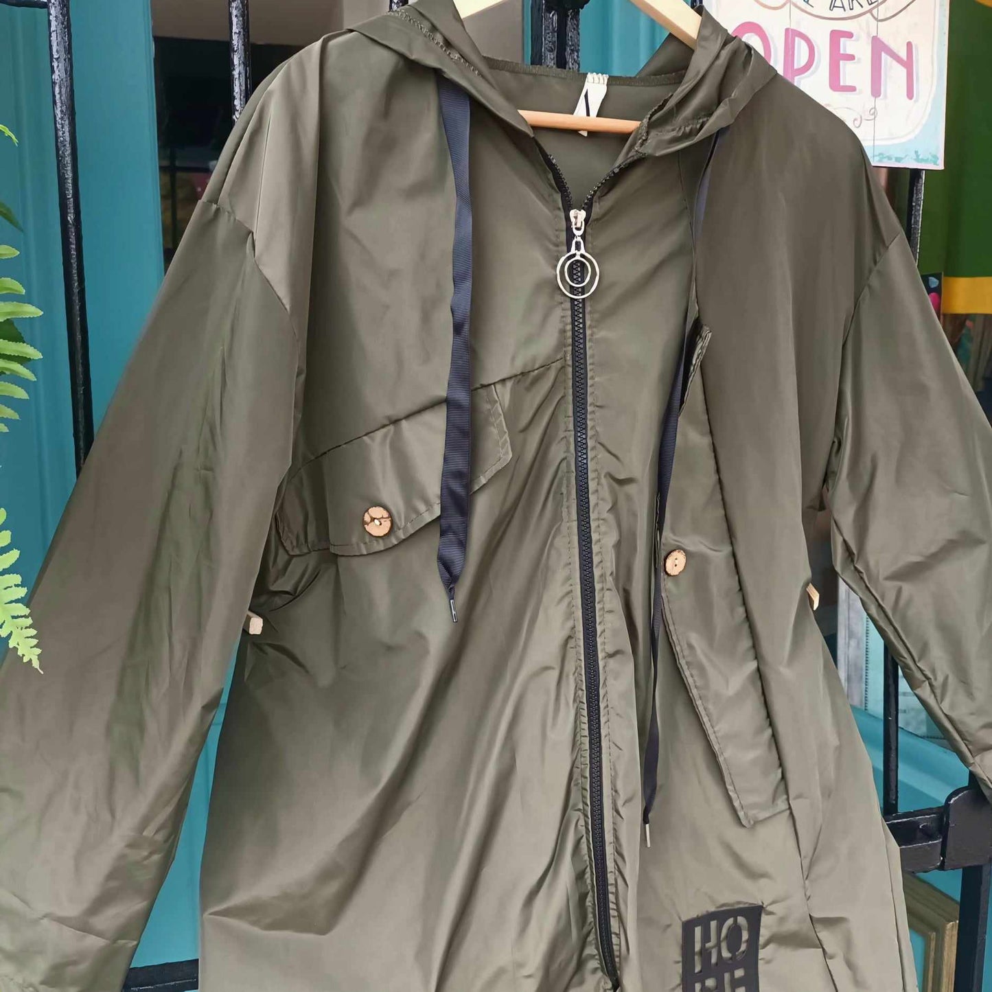 THE 'SUPERNOVA' KHAKI KAGOULE WITH HOPE MOTIF, FEATURE ZIP AND BUTTON DETAIL