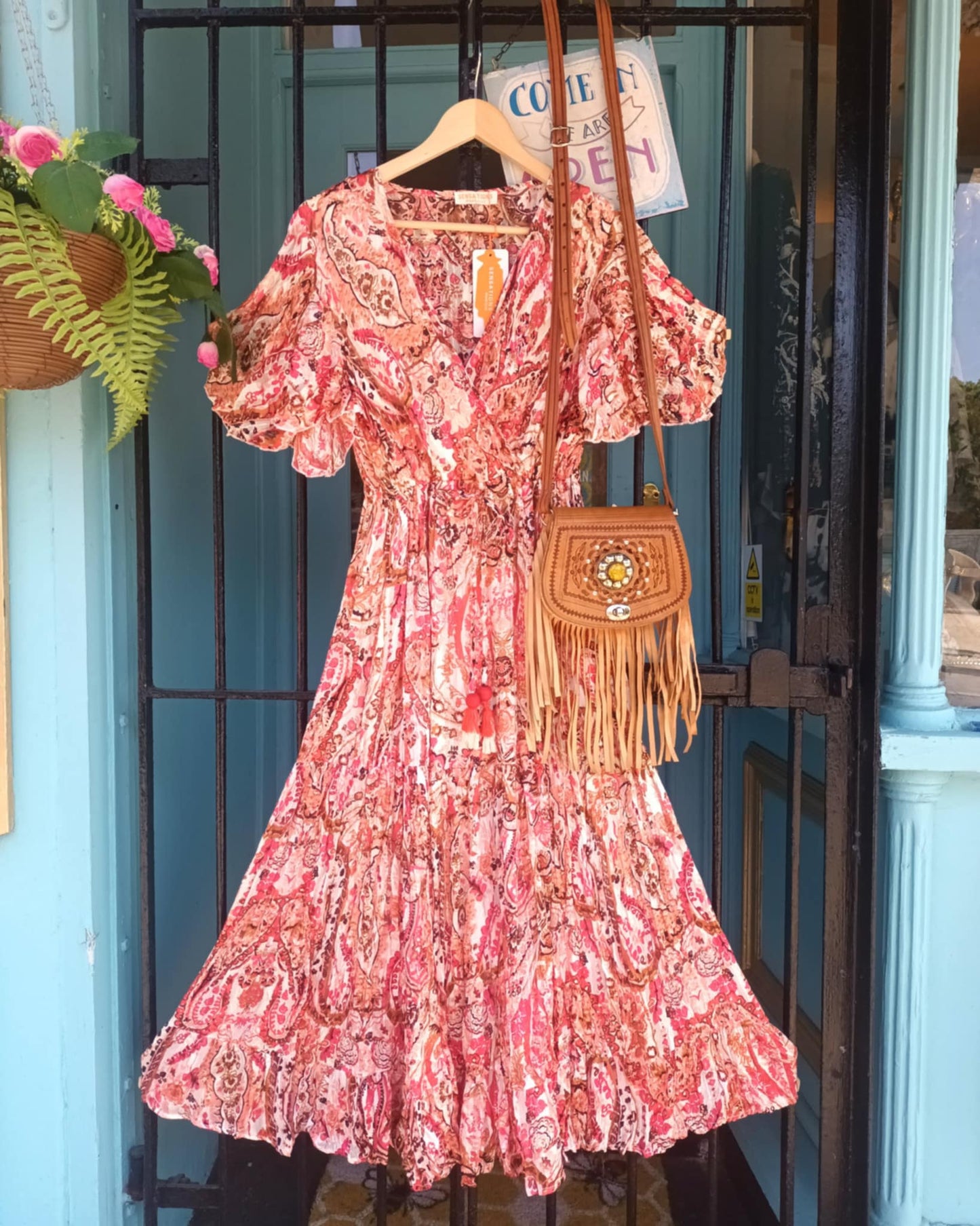 'ELEANOR; STUNNING PLISSE ANGEL SLEEVE MAGIC DRESS WITH SWISHY HEM AND TASSEL DETAIL. CORAL PRINT