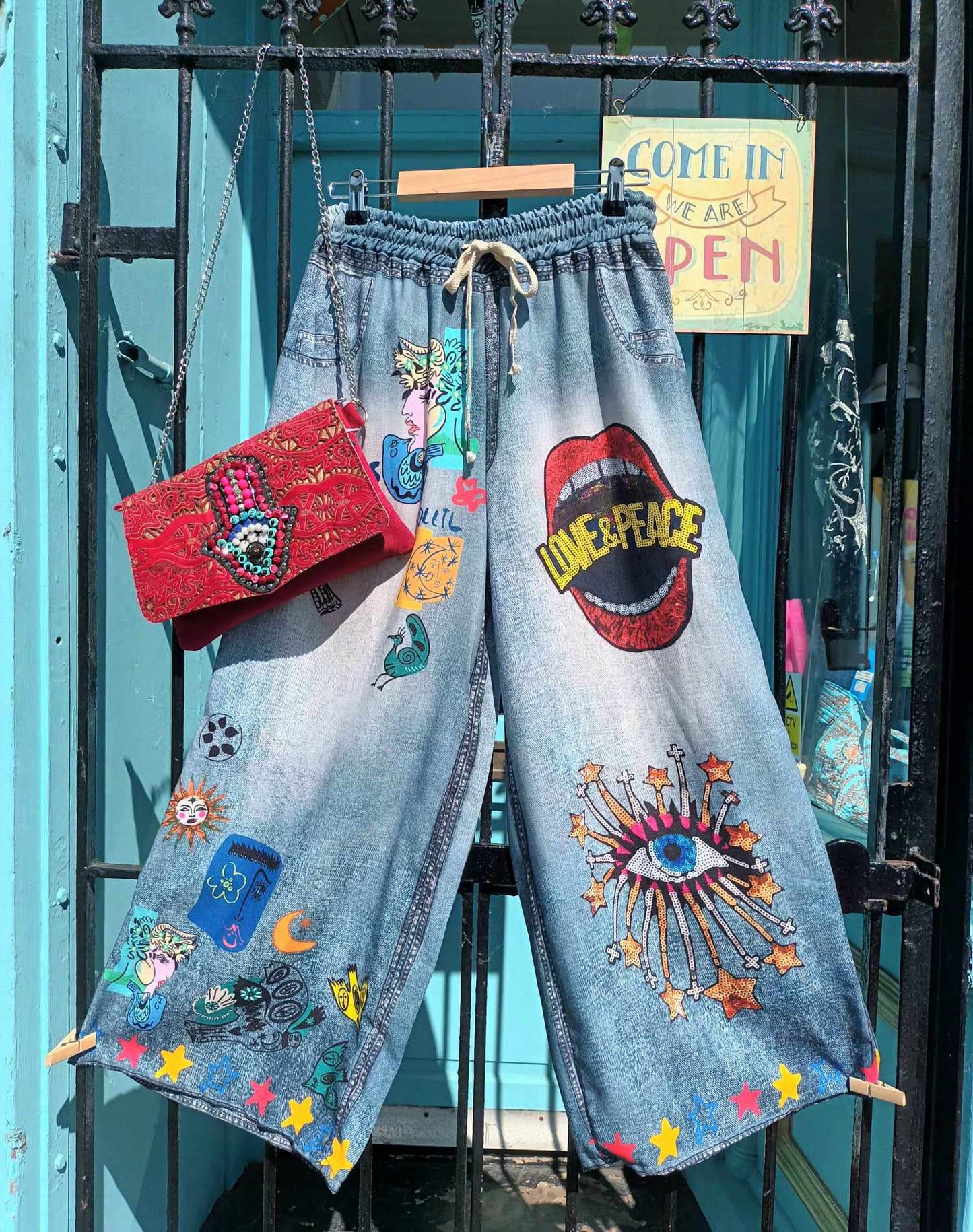 THE 'JEAN JEANIE LOVE AND PEACE' MYSTIC PRINT WIDE LEGGED DRAWSTRING WAIST TROUSERS