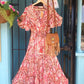'ELEANOR; STUNNING PLISSE ANGEL SLEEVE MAGIC DRESS WITH SWISHY HEM AND TASSEL DETAIL. CORAL PRINT