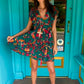 THE 'IBIZA SUNSET' VIBRANT BIRD OF PARADISE PRINT FLIPPY SUMMER DRESS WITH TASSEL BACK DETAIL FROM OUR EXCLUSIVE SPANISH COLLECTION