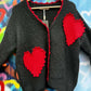 THE 'LOVE IS' SUPERSOFT FLUFFY CARDIGAN WITH APPLIQUE KNITTED HEARTS IN BLACK OR PALE GREY
