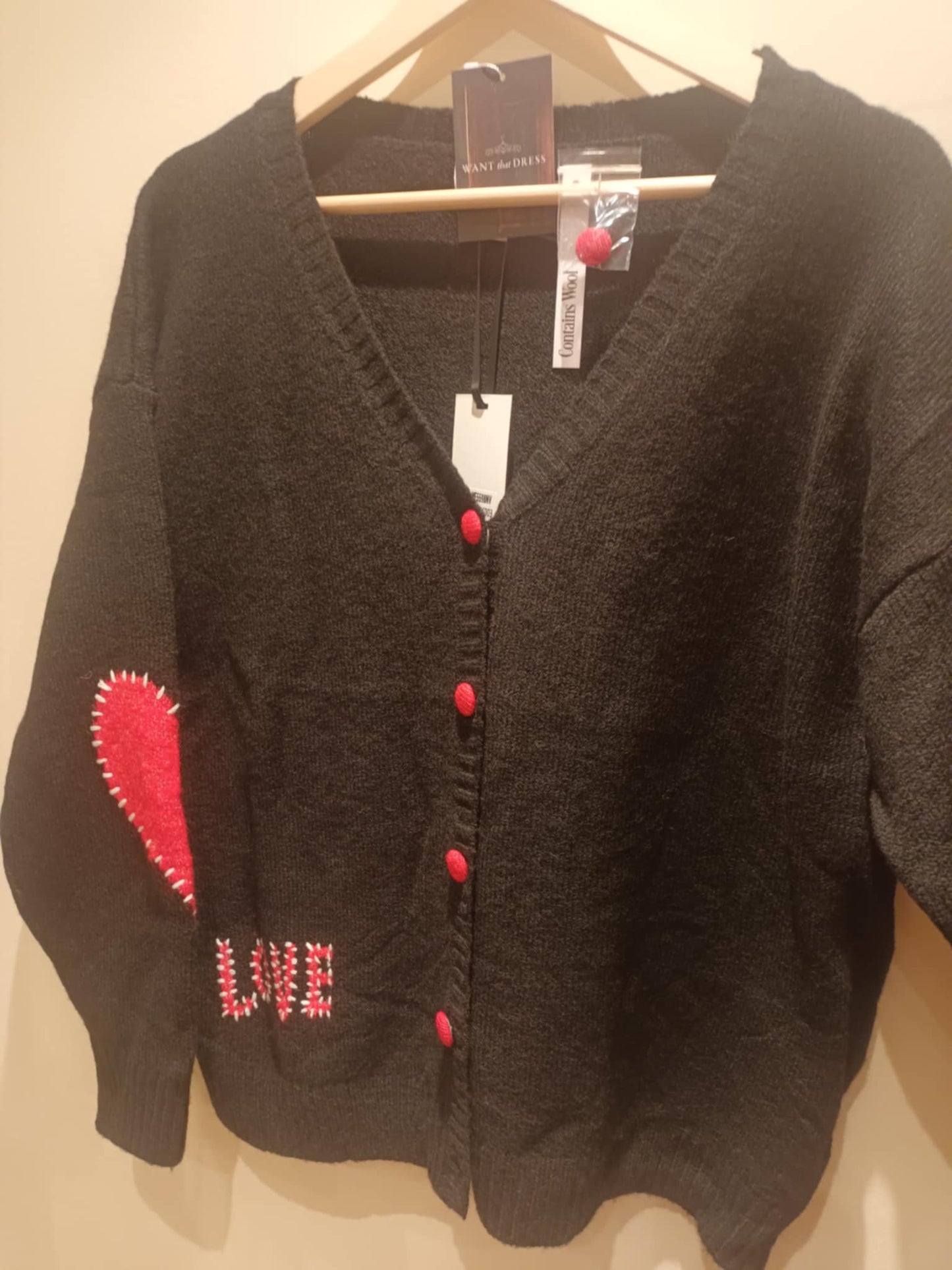THE 'LOVE IS...' CUTE AND COSY HEART PATCH CARDIGAN WITH BLANKET STITCH DETAIL