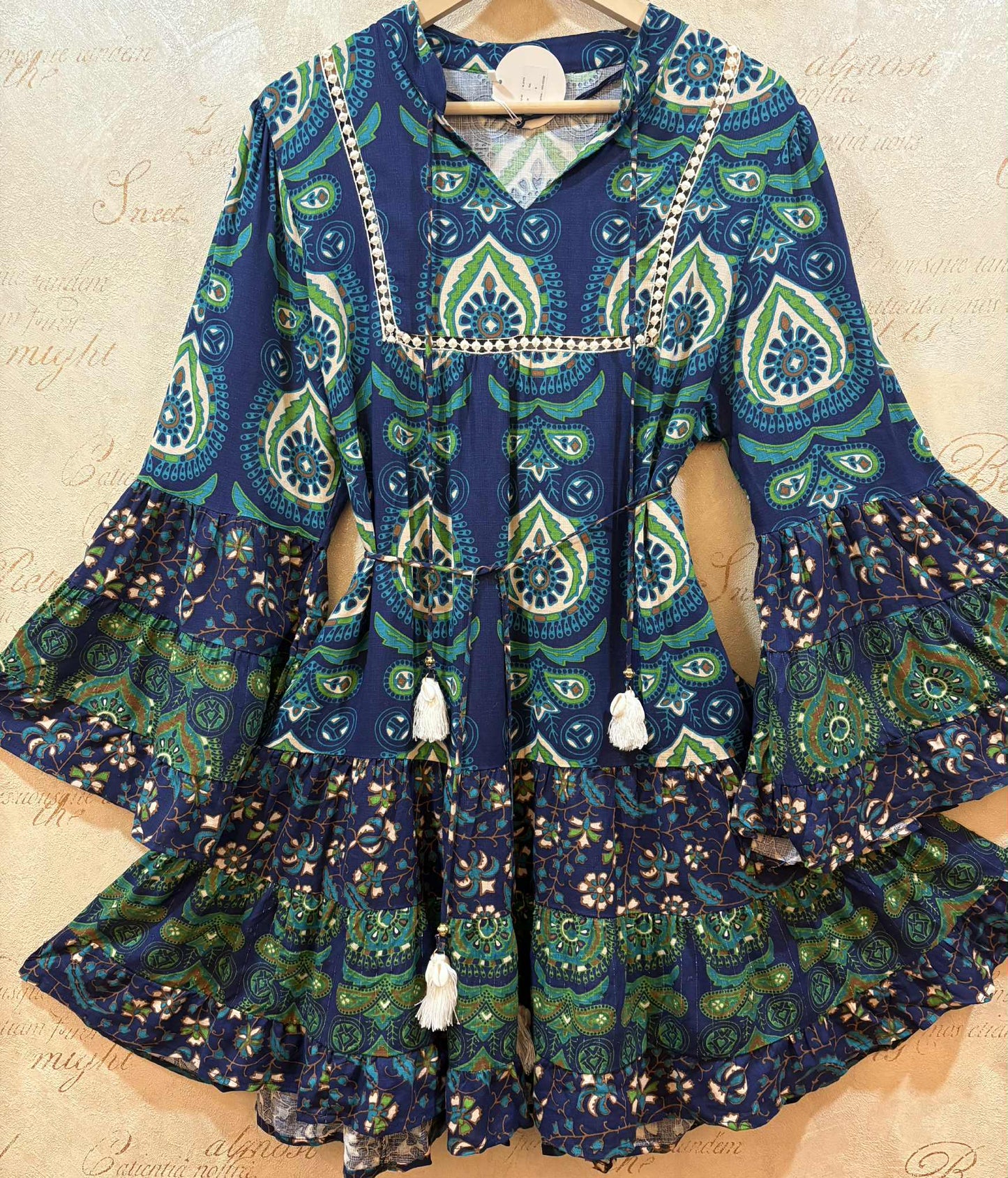 THE 'PANDORA' VINTAGE 70'S STYLE BELL SLEEVE TASSEL DETAIL DRESS WITH FULL AND FLIPPY HEMLINE