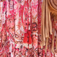 'ELEANOR; STUNNING PLISSE ANGEL SLEEVE MAGIC DRESS WITH SWISHY HEM AND TASSEL DETAIL. CORAL PRINT