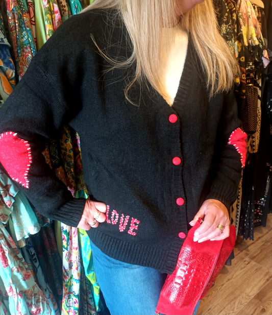 THE 'LOVE IS...' CUTE AND COSY HEART PATCH CARDIGAN WITH BLANKET STITCH DETAIL