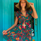 THE 'IBIZA SUNSET' VIBRANT BIRD OF PARADISE PRINT FLIPPY SUMMER DRESS WITH TASSEL BACK DETAIL FROM OUR EXCLUSIVE SPANISH COLLECTION